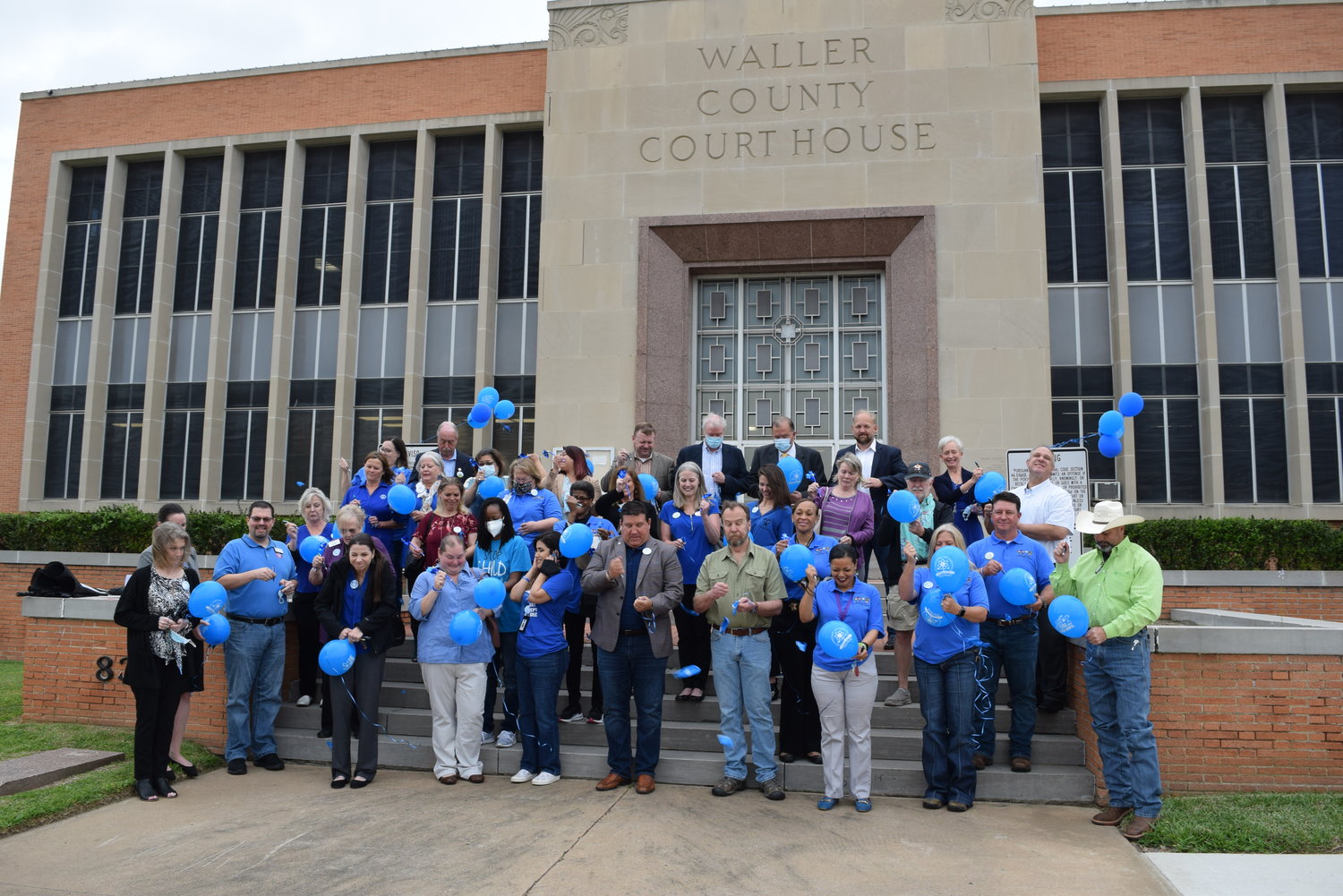 Waller County officials join members of various public and nonprofit agencies that serve the victims of sexual violence and child abuse throughout the county for a balloon-popping ceremony on the front steps of the Waller County Courthouse.